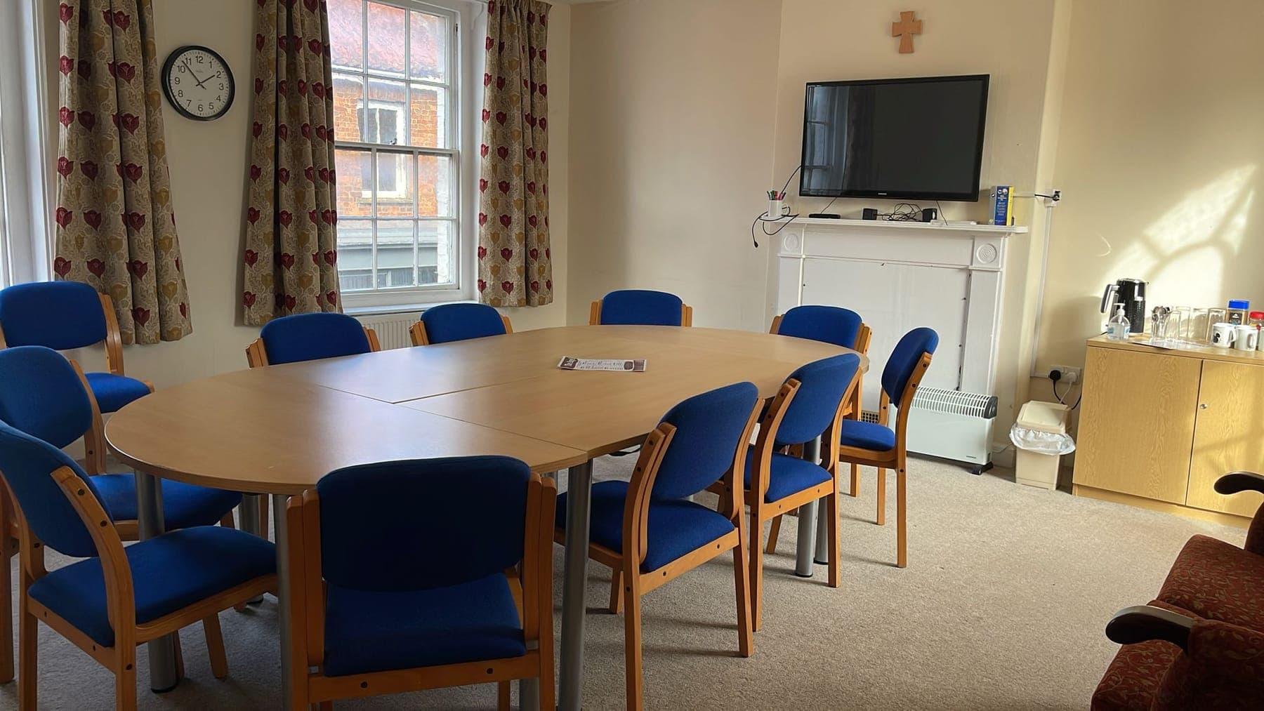 The meeting room set up with an oval table and chairs around it